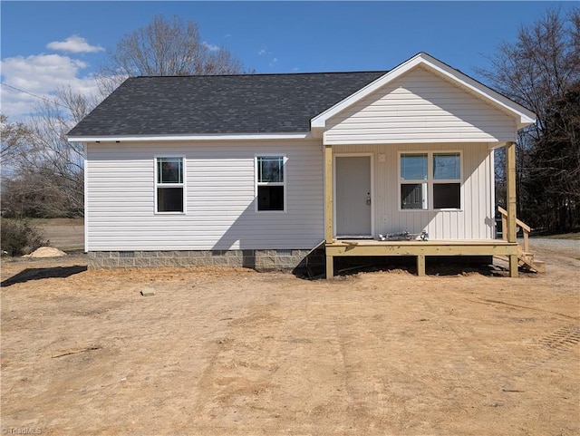 view of front of house with covered porch, crawl space, and roof with shingles