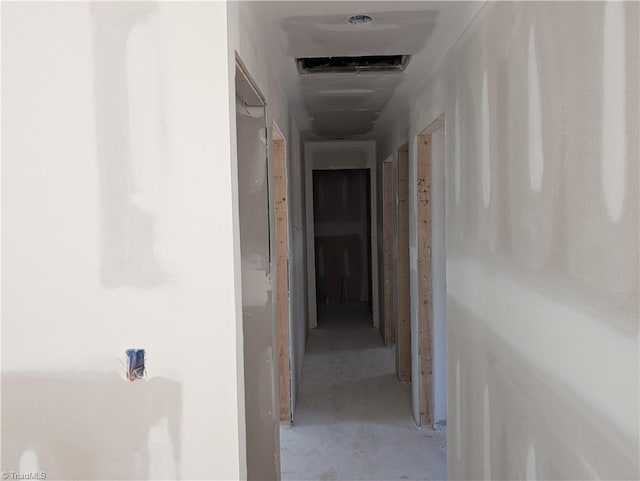 corridor featuring concrete flooring and visible vents