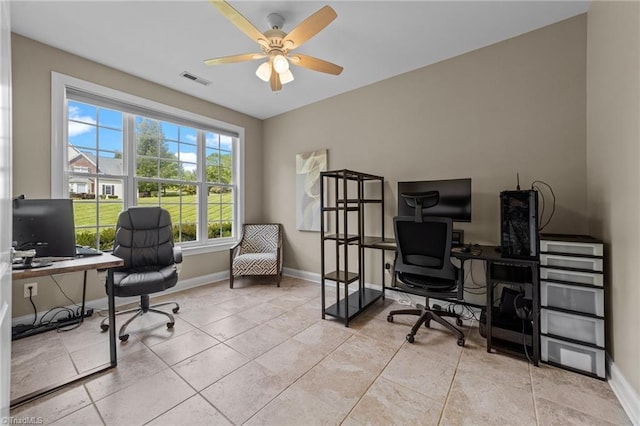 tiled home office featuring baseboards, ceiling fan, and visible vents