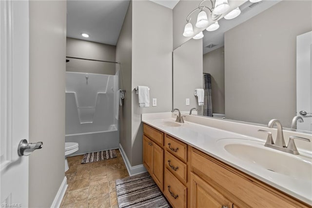 bathroom featuring double vanity, toilet, a sink, and shower / tub combo
