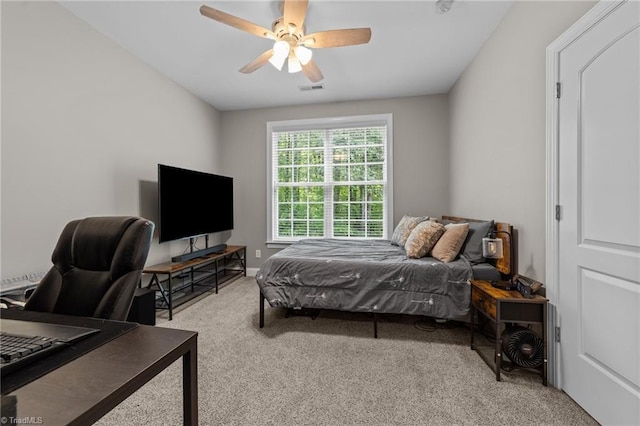 carpeted bedroom featuring a ceiling fan and visible vents