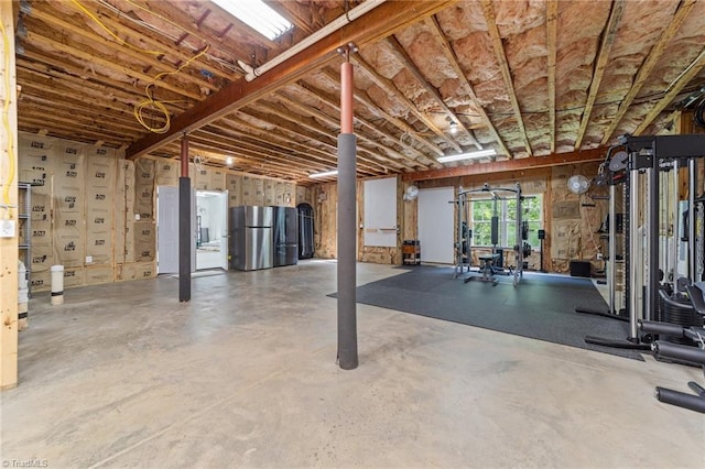 basement featuring freestanding refrigerator
