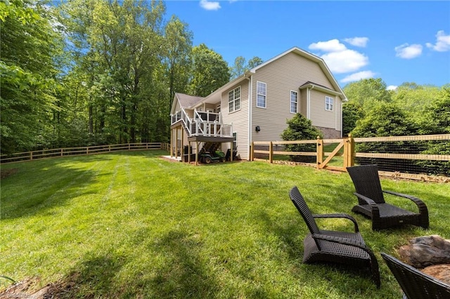 rear view of house with a fenced backyard and a lawn