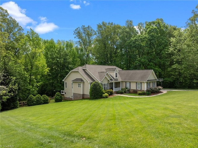 ranch-style house with a view of trees and a front yard