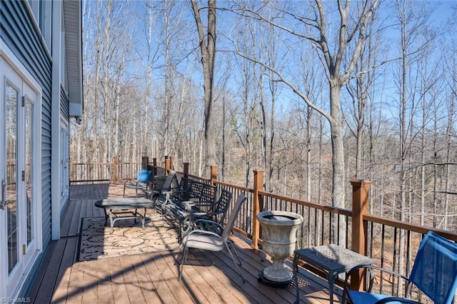wooden deck with a view of trees