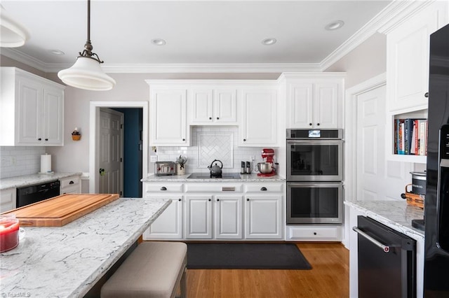 kitchen with pendant lighting, dark wood-type flooring, light stone counters, black appliances, and white cabinets