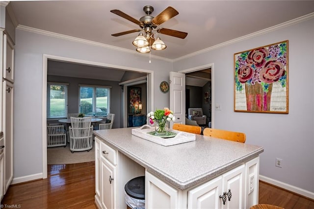 kitchen with dark wood-type flooring, a center island, and white cabinets