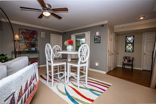 dining area featuring hardwood / wood-style flooring, ceiling fan, and ornamental molding