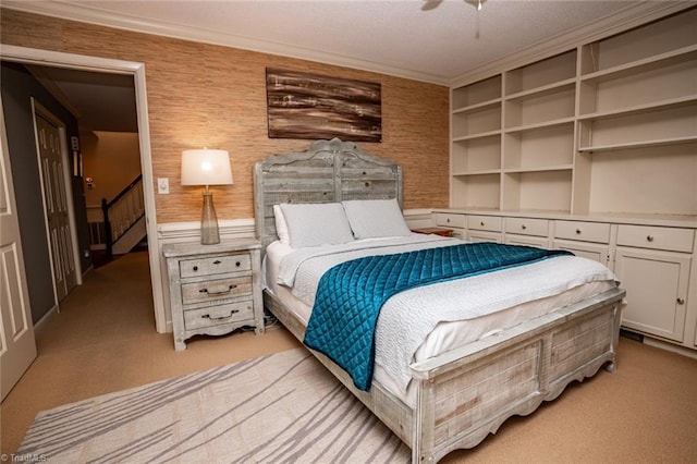 bedroom with crown molding, light colored carpet, and ceiling fan