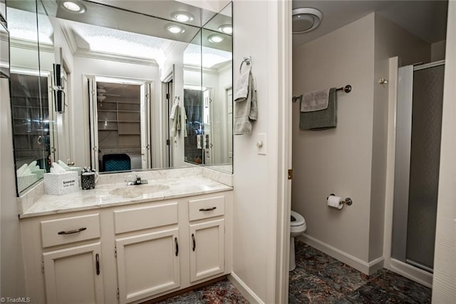 bathroom with ornamental molding, toilet, an enclosed shower, and vanity