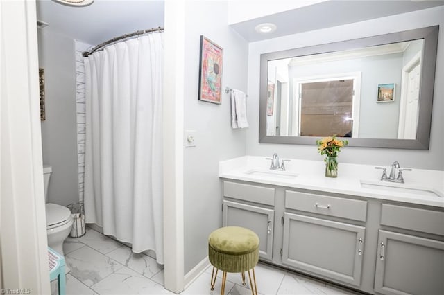 bathroom featuring vanity, toilet, and walk in shower