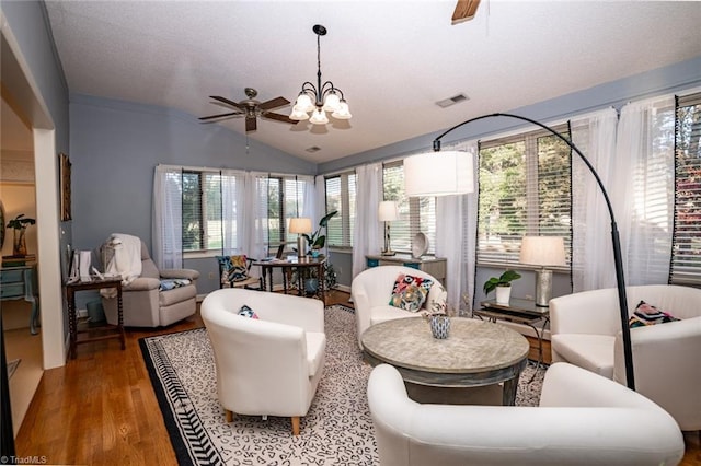 interior space with lofted ceiling, ceiling fan with notable chandelier, and hardwood / wood-style flooring