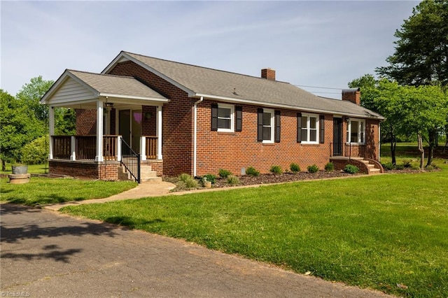 single story home featuring a chimney, brick siding, a front yard, and a shingled roof