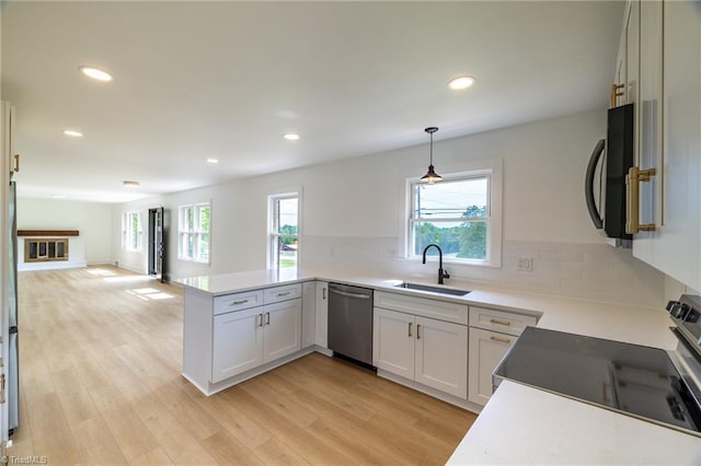 kitchen featuring dishwasher, a sink, healthy amount of natural light, electric range oven, and recessed lighting