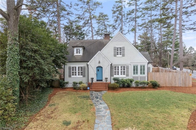 cape cod home with a front lawn