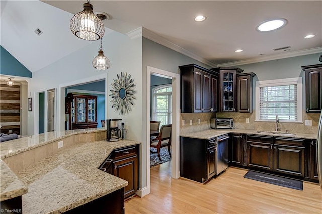 kitchen featuring stainless steel dishwasher, a sink, light wood-type flooring, healthy amount of natural light, and recessed lighting