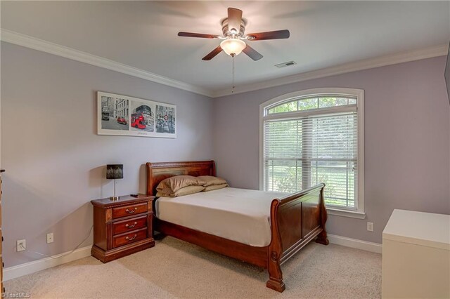 bedroom with ornamental molding, baseboards, light carpet, and a ceiling fan