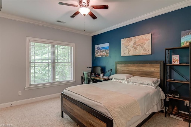 carpeted bedroom with ornamental molding, baseboards, and ceiling fan