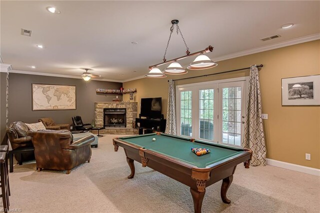 recreation room with light carpet, crown molding, pool table, a ceiling fan, and a fireplace