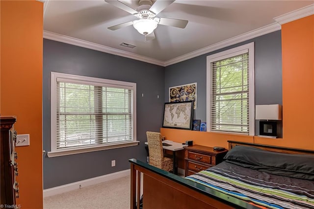 carpeted bedroom featuring multiple windows, baseboards, crown molding, and ceiling fan