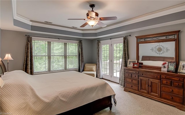 bedroom featuring access to outside, light colored carpet, a raised ceiling, ceiling fan, and crown molding