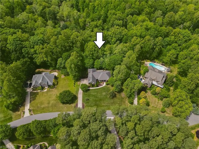 aerial view of property's location with a forest