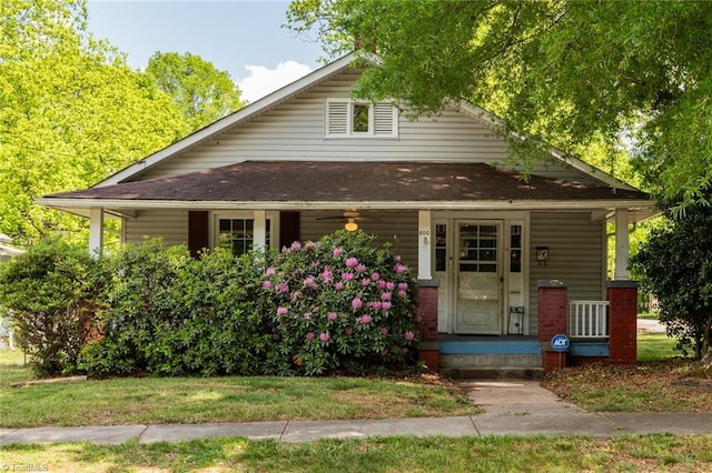 bungalow-style home with a porch and a shingled roof