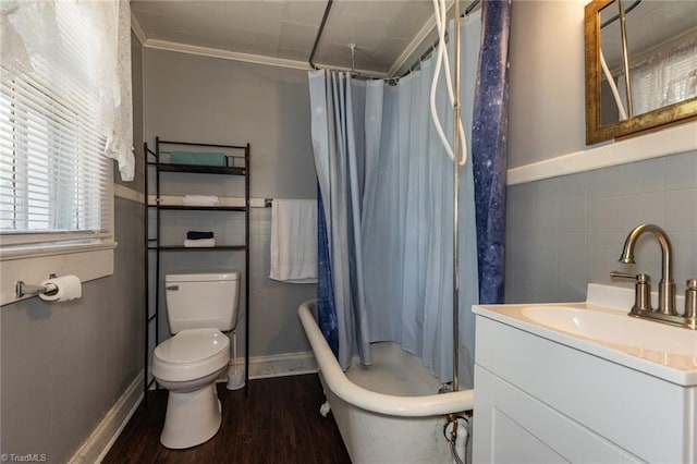 full bath featuring tile walls, wood finished floors, toilet, crown molding, and vanity