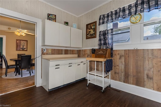 kitchen with dark wood finished floors, light countertops, white cabinetry, and ornamental molding
