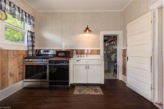 kitchen with black appliances, ornamental molding, white cabinetry, light countertops, and dark wood finished floors