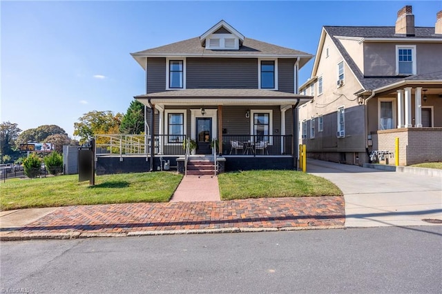 view of front property featuring a front yard and a porch