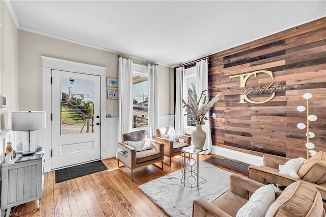 interior space with crown molding, a healthy amount of sunlight, and light hardwood / wood-style flooring