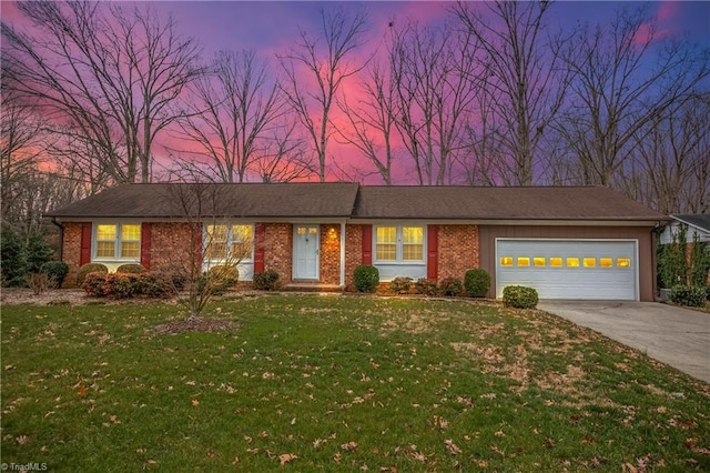 ranch-style home with brick siding, a lawn, and concrete driveway