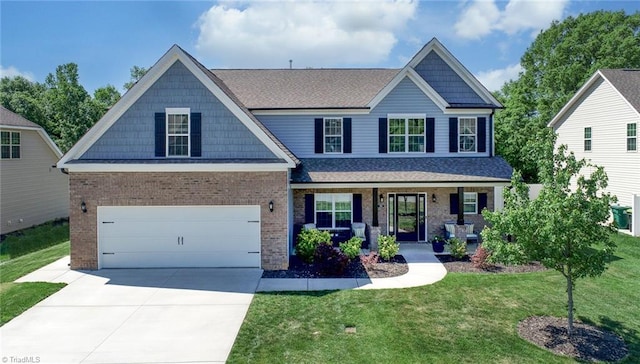 view of front of home with covered porch, a shingled roof, concrete driveway, and a front lawn