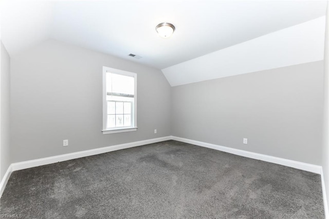 bonus room with baseboards, visible vents, and lofted ceiling