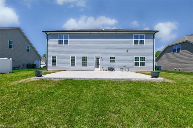 rear view of property featuring a patio area and a yard
