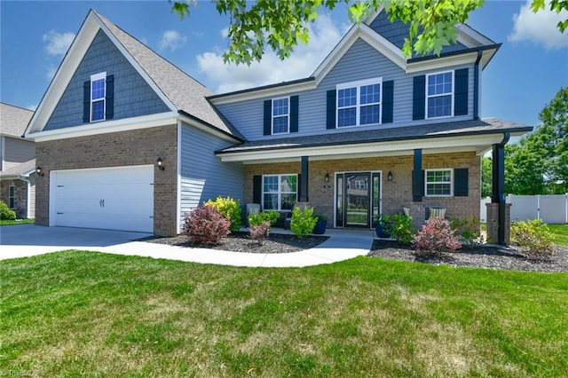 view of front of home with a garage, fence, a front lawn, and brick siding