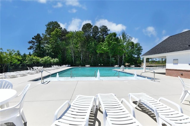 pool with fence and a patio area