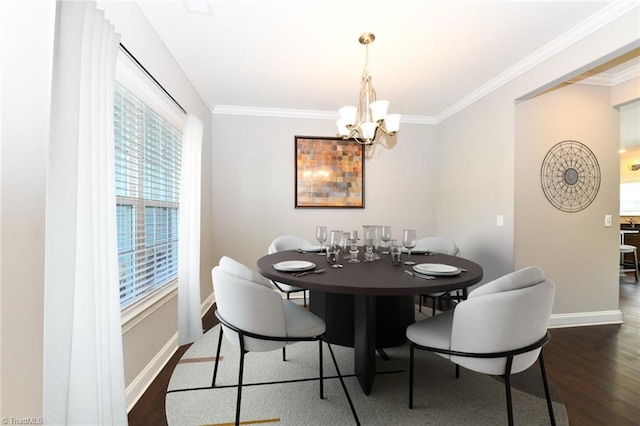 dining area with baseboards, a notable chandelier, ornamental molding, and wood finished floors