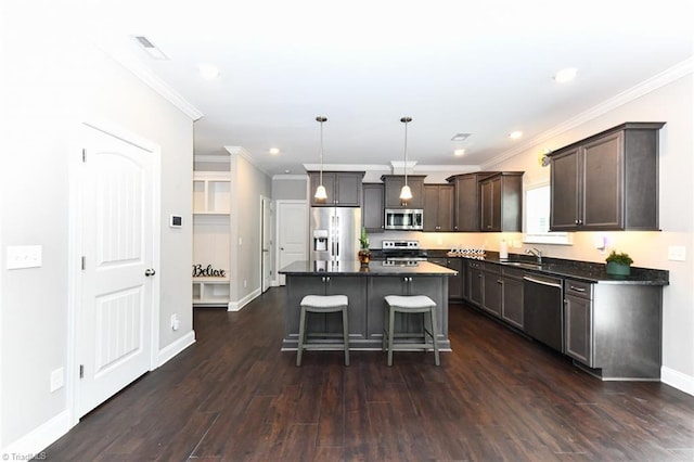 kitchen featuring a breakfast bar area, dark countertops, dark wood finished floors, dark brown cabinets, and stainless steel appliances