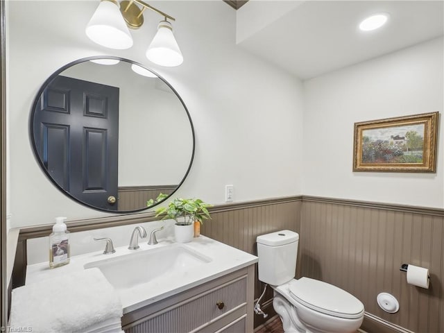 511 Circle Dr, Burlington, NC 27215 - bathroom with toilet, vanity, and a wainscoted wall