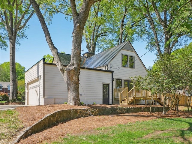 511 Circle Dr, Burlington, NC 27215 - rear view of property featuring a garage, a deck, metal roof, and stairway