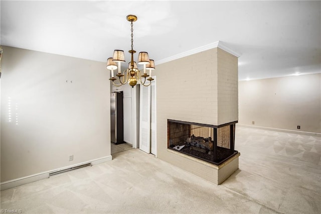 carpeted living room featuring crown molding, a fireplace, and a chandelier