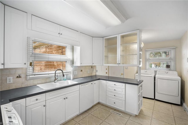 kitchen featuring white cabinetry, sink, separate washer and dryer, and dishwasher