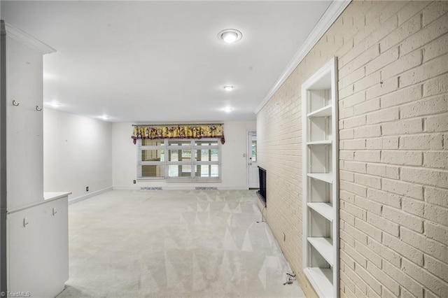 interior space featuring crown molding, brick wall, and light carpet