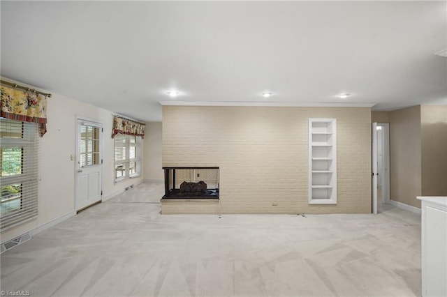 unfurnished living room featuring light colored carpet, a multi sided fireplace, and built in features