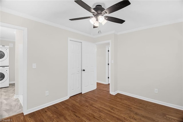 4126 Old Way Rd, Sophia, NC 27350 - unfurnished bedroom with estacked washer and dryer, crown molding, wood finished floors, ceiling fan, and a closet