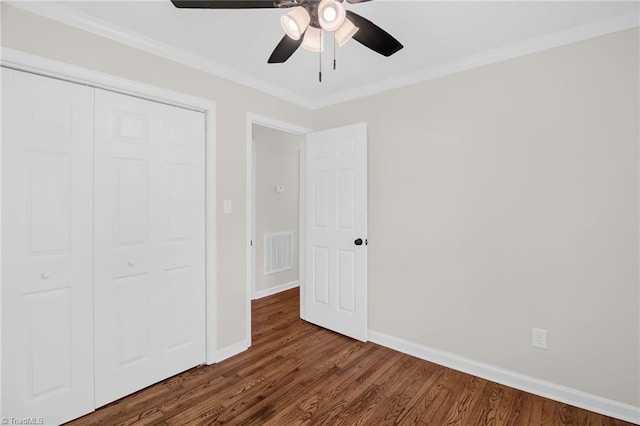 4126 Old Way Rd, Sophia, NC 27350 - unfurnished bedroom with dark wood-style flooring, a closet, crown molding, and a ceiling fan