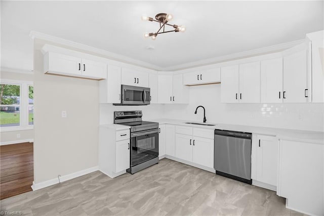 4126 Old Way Rd, Sophia, NC 27350 - kitchen featuring stainless steel appliances, a chandelier, crown molding, white cabinets, and light countertops