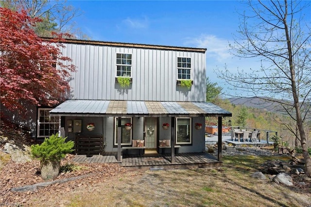 view of front facade featuring covered porch and metal roof